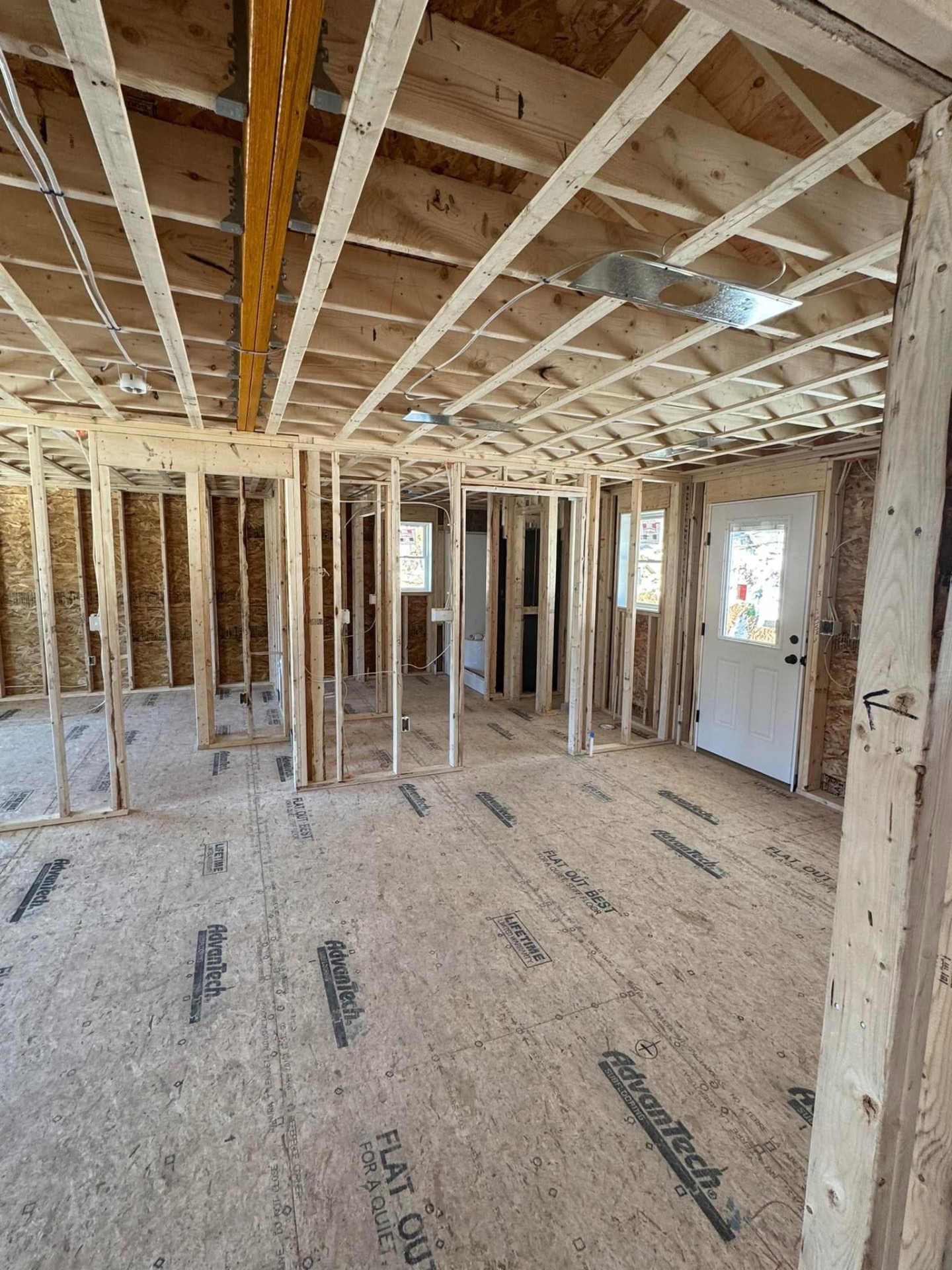Interior framing — partition walls laid out for the living space, bathroom, and entry door.