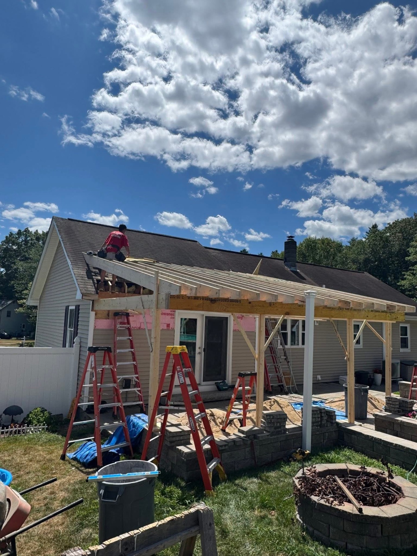 Back porch — full rafter run framed off the back of the house over the patio door and slider.
