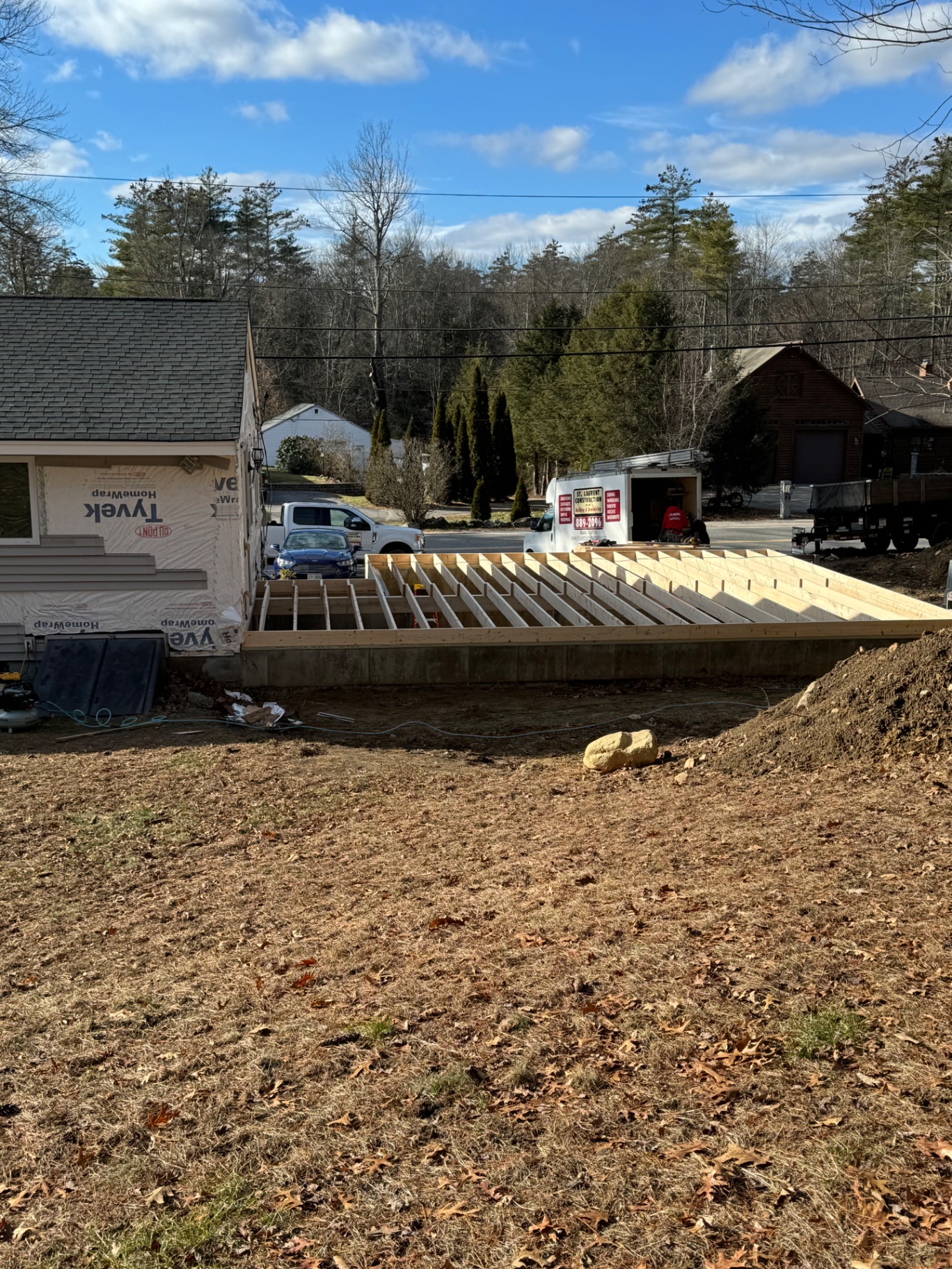 Floor framing — pressure-treated floor system tied into the existing home over the new foundation.