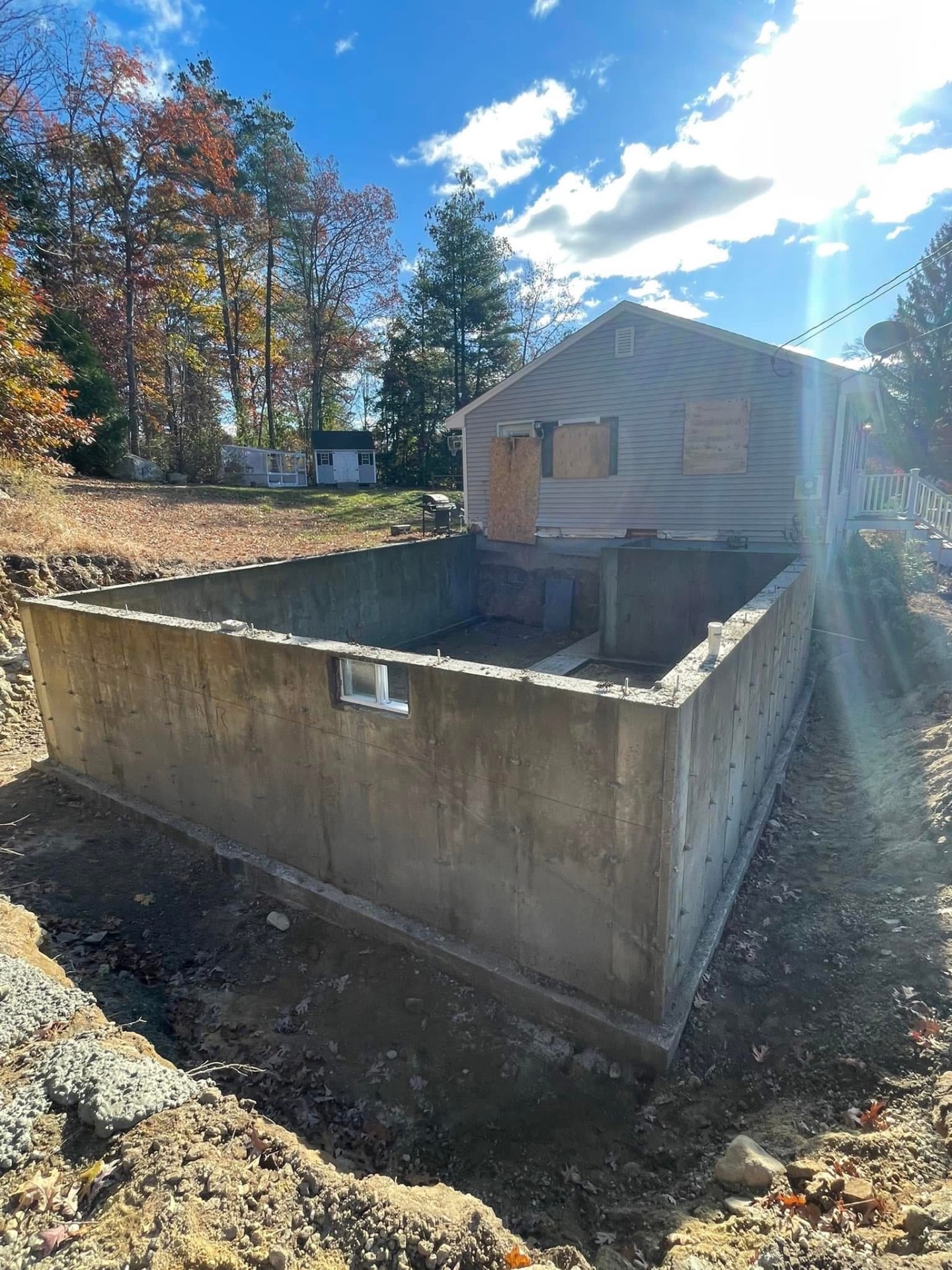 Foundation — poured concrete walls and slab set and cured.