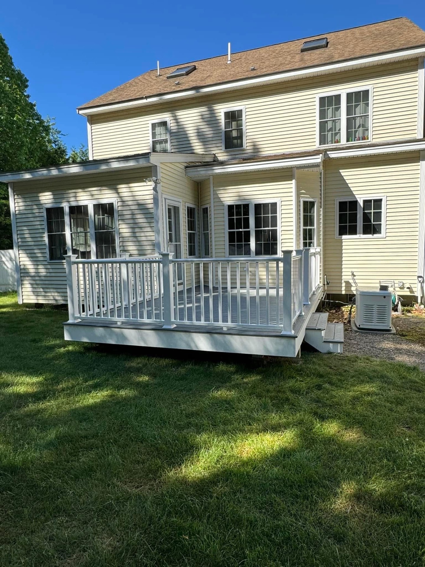 Rear view — clean lines, wrapped fascia, and a bright new outdoor living space.