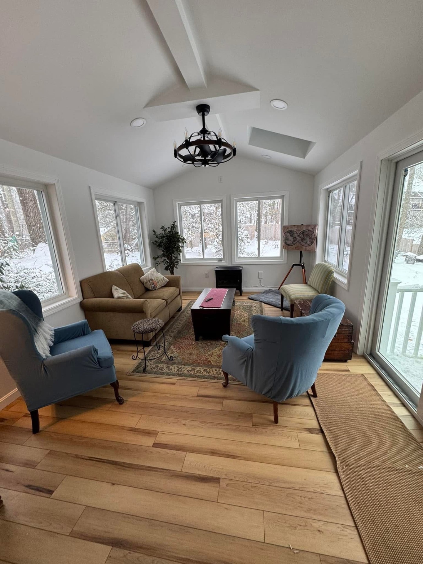 Furnished four season room — a bright, year-round living space off the back of the home.