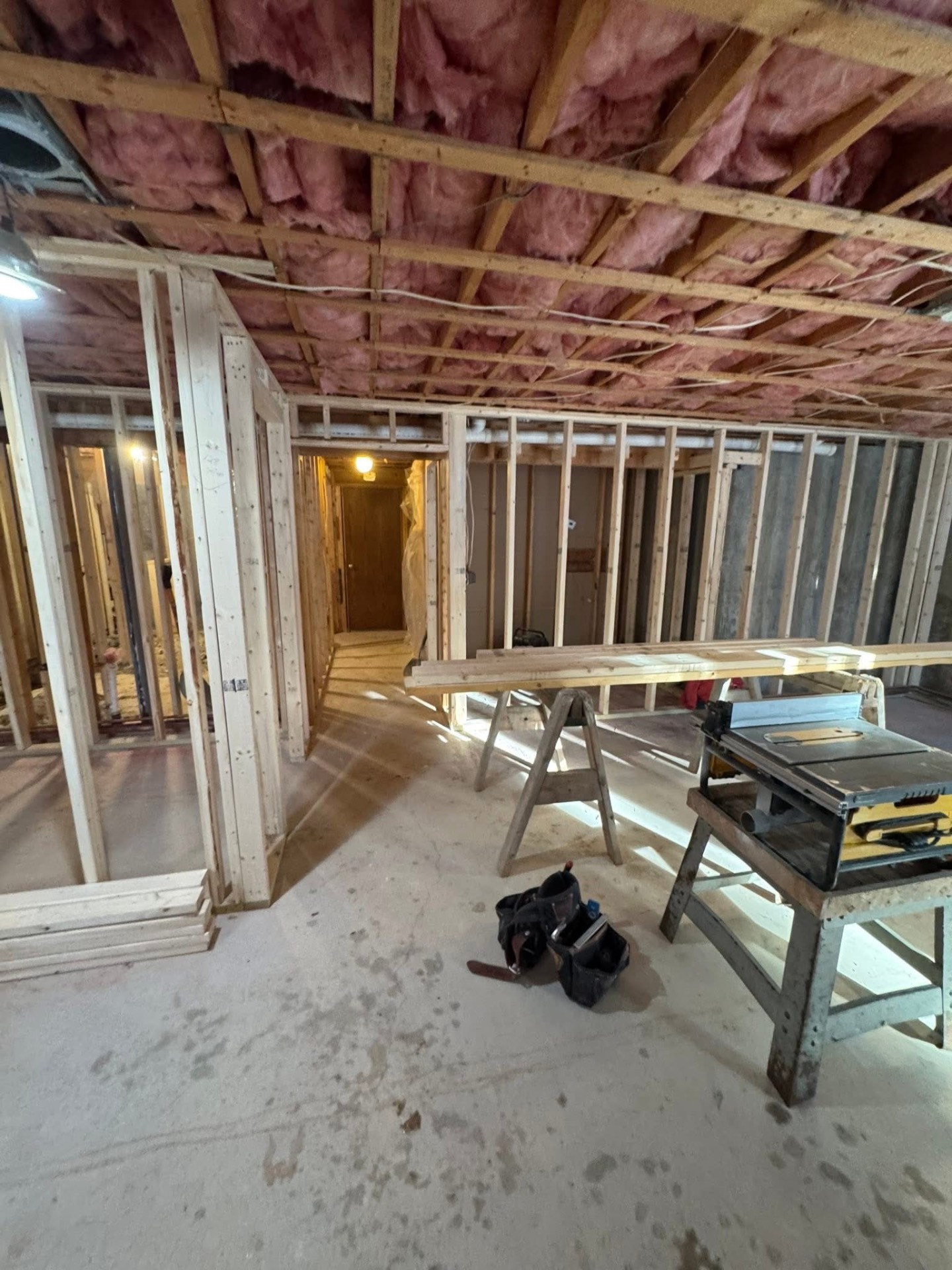 During — new interior partition walls framed to lay out the living area, bathroom, and hallway.